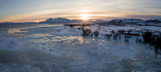 Ice and snow sunset: Scandinavia beautiful landscape of norways lofoten islands in winter aerial / drone