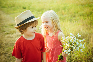 Beautiful little couple - boy and girl embracing. Childhood concept. Summer portrait of happy cute child. Romantic and love. Love concept. First love. Happy Valentines day.