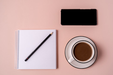 Obraz na płótnie Canvas Notebook, a pen, smartphone and a cup of coffee.
