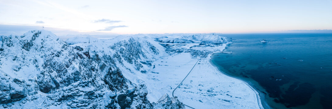 Arial drone view of Icy and snowy mountain on Norways Andenes coastline, And&oslash;ya