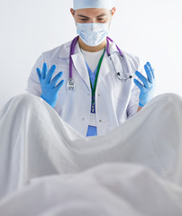 male obstetrician and scrubs nurse are delivered to the pregnant woman in the delivery room of the hospital