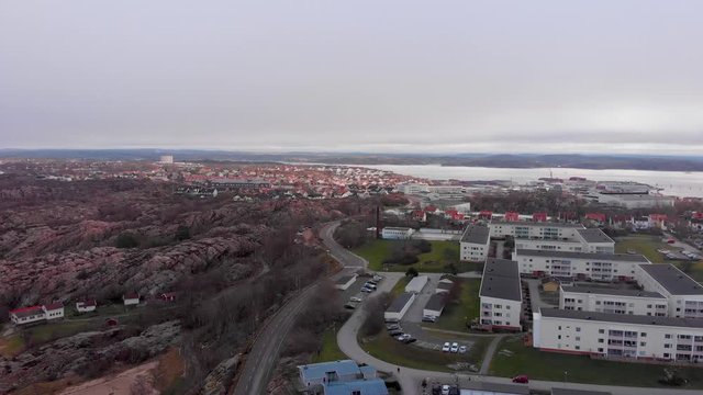 The beautiful and peaceful city of Lysekil, Sweden with the view of the ocean in the distance - Aerial shot