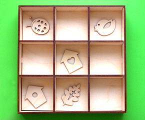 wooden toys in a box, spring coming concept. small birdhouses, bird, ladybug