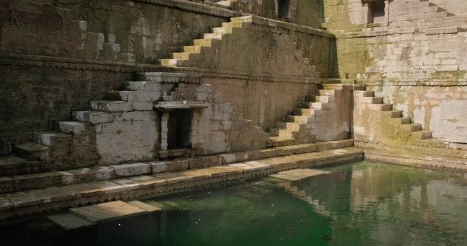 Water storage and Toorji Ka Jhalra Baoli stepwell - one of water sources in Jodhpur, Rajasthan, India. Camera zoom in