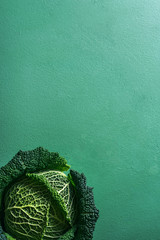 Savoy cabbage freshly harvested on a green table. Detox food