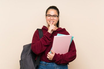 Fototapeta premium Young student Asian girl woman over isolated background doing silence gesture