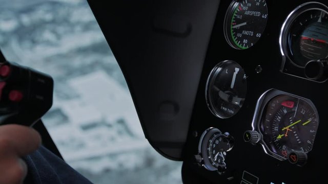 Helicopter cockpit instrument panel closeup shot and pilot hand on the stick. High quality 4k prores