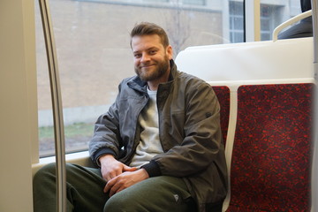 Man with a beard riding the streetcar downtown Toronto