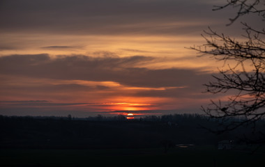 Fototapeta premium Dramatic sunrise above the hill and forest