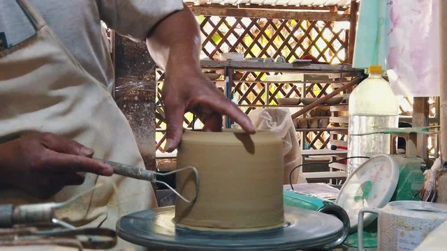 Close Slow Motion Shot of a Craftsman Creating a Pot on a Pottery Wheel in the Studio