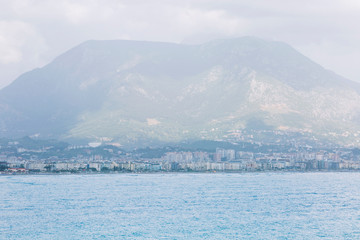 Fototapeta premium Resort town on the sea against the backdrop of the mountains. Beautiful landscape.