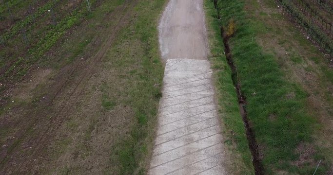 Aerial view above rustic path tilt up to Cantoniera residential house. Frescobaldi vineyard countryside, Chianti wine area. Arno river valley near Florence. Pontassieve, Tuscany. Italy