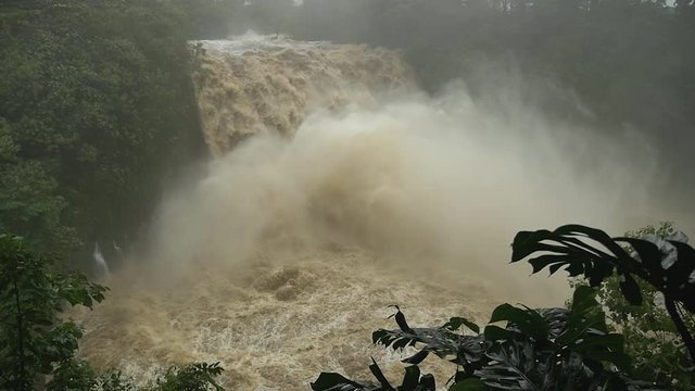 dolly right slo mo of flash flooding rainbow falls in hilo