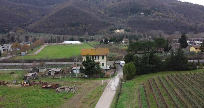 Cantoniera countryside house  aerial orbit right. Frescobaldi winery, Chianti winemaking vineyard rows. Arno river valley near Florence. Pontassieve, Tuscany. Italy