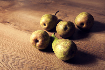 Big ripe pears on soft wooden background