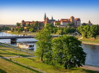 Krakow, Poland, with Wawel castle and cathedral, Vistula river, Podwawelski bridge, a restaurant on the  barge, trees and promenades in summer. Aerial view