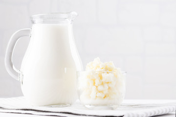Homemade fermented beverage kefir with kefir grains in bowl on a white background, concept of natural fermented food and intestinal health