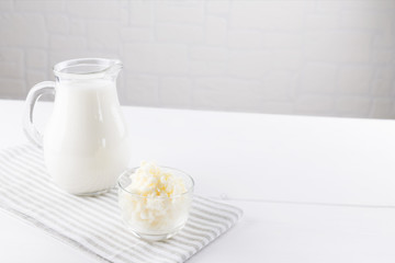 Homemade fermented beverage kefir with kefir grains in bowl on a white background, concept of...