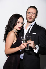 beautiful couple clinking with champagne glasses for valentines day on white