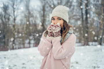 Winter young woman portrait. Beauty Joyful Model Girl laughing and having fun in winter park. Beautiful young female outdoors, Enjoying nature, wintertime