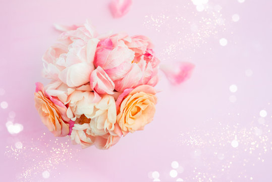 Fresh bunch of pink peonies and roses on pink background. Toned image, card Concept, pastel colors