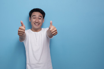 Young Man Showing Thumbs Up Gesture OK Sign