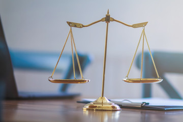 Brass scales are placed on the tables within the lawyer's office for use as decorations and as a symbol of justice in judicial proceedings.