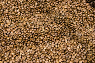 Bunch of freshly roasted coffee arabica beans.