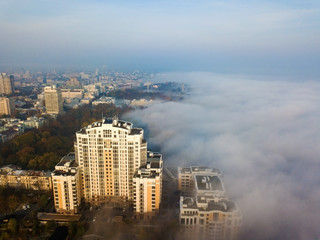 Aerial drone view. Kiev in the dense morning fog.