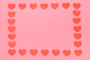 a lot of red small hearts put on a pink background, those are put around the picture
