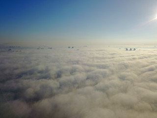 Obraz premium Aerial drone view. Fog rises from the Dnieper River and envelops Kiev.