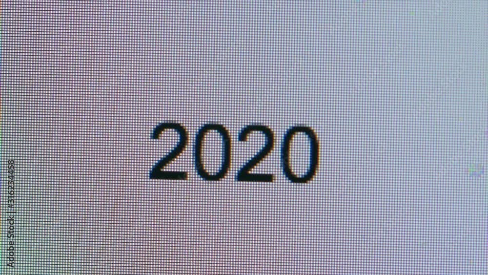 Poster cursor typing out 2020 flashing cursor on computer screen bright white page. new year new decade wri