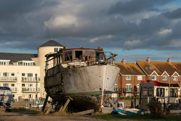 Fototapeta na wymiar Littlehampton, West Sussex, UK, January 17, 2020. Old boat in need of repair and restoration on the banks of The River Arun.