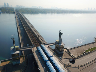 Drone view. Two trains of the Kiev metro at a stop at the beginning of the bridge.