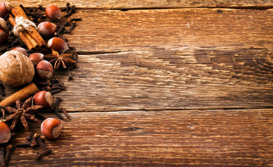 Spices on a old wooden background. Cinnamon, nuts, anise frame. Autumn background. Christmas background. Top view.
