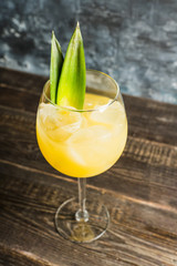 Pineapple cocktail in wine glass. Selective focus. Shallow depth of field.