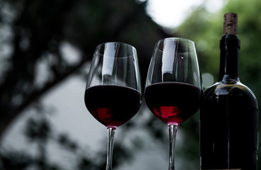 Food and drink, holidays party concept.  red wine in a glass on the bar, blurred background....