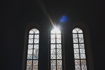 Vertical high Windows of the temple with sunlight. Three