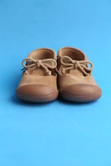 brown leather child shoes in color background