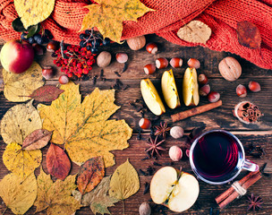 Christmas hot mulled wine with spices and fruits on a old wooden background. Autumn background. Christmas background. Top view.