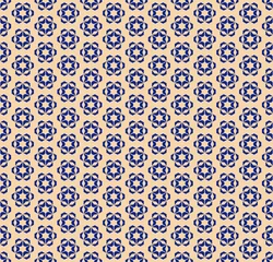 Wallpaper murals Small flowers Vector golden geometric floral seamless pattern. Elegant deep blue and gold ornamental texture with small flowers, star shapes, snowflakes. Abstract festive background. Luxury repeat design for decor