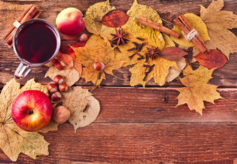 Christmas hot mulled wine with spices and fruits on a old wooden background. Autumn background, Christmas background. Text space.