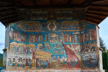Fototapeta na wymiar Voronet Monastery, founded in the 15th century, located in Voronet, Romania. Stone religious building of Christian Orthodox church built with painted walls.