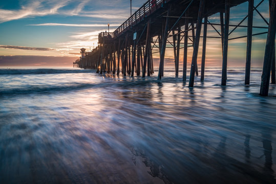 Fototapeta Long exposure sunset and surf at the pier