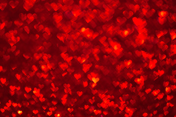 Fototapeta na wymiar Abstract light, red bokeh pattern in heart shape. St Valentines Day or Holiday concept, background image.