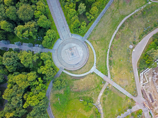 Aeiral drone view. Walking paths in the park between the trees.