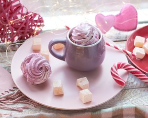 Cup of coffee with meringues and marshmallows, Turkish delight on a plate, hearts, illumination, against the background of a window, homeliness, Valentine's day, romantic greeting, happy birthday
