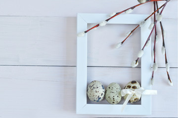 White photo frame and pussy willow branches with catkins on a light background. Easter Postcard Template