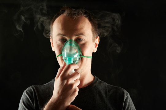 Portrait Of Man Using Respirator Mask