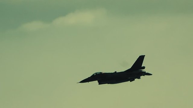 The fighter is descending over the clouds
